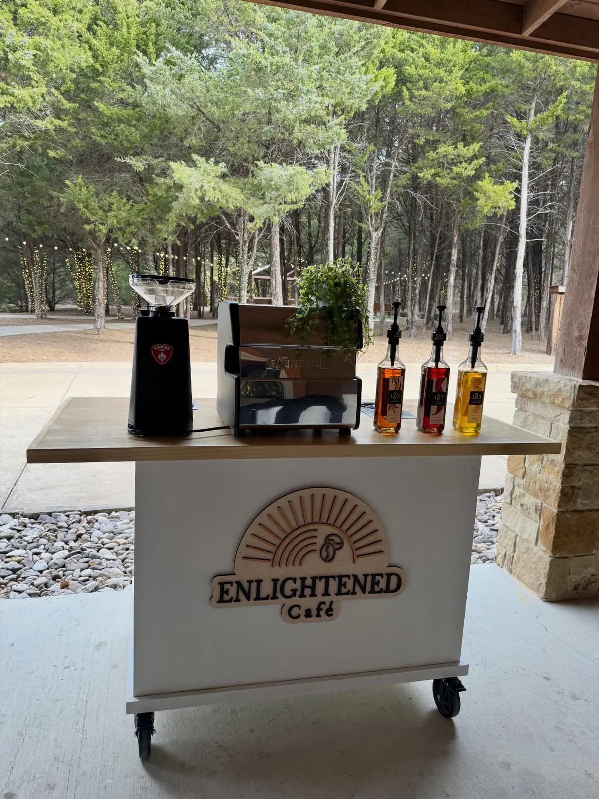 Enlightened Café mobile coffee cart set up for an event at a DFW ranch venue with espresso machine and syrup bar