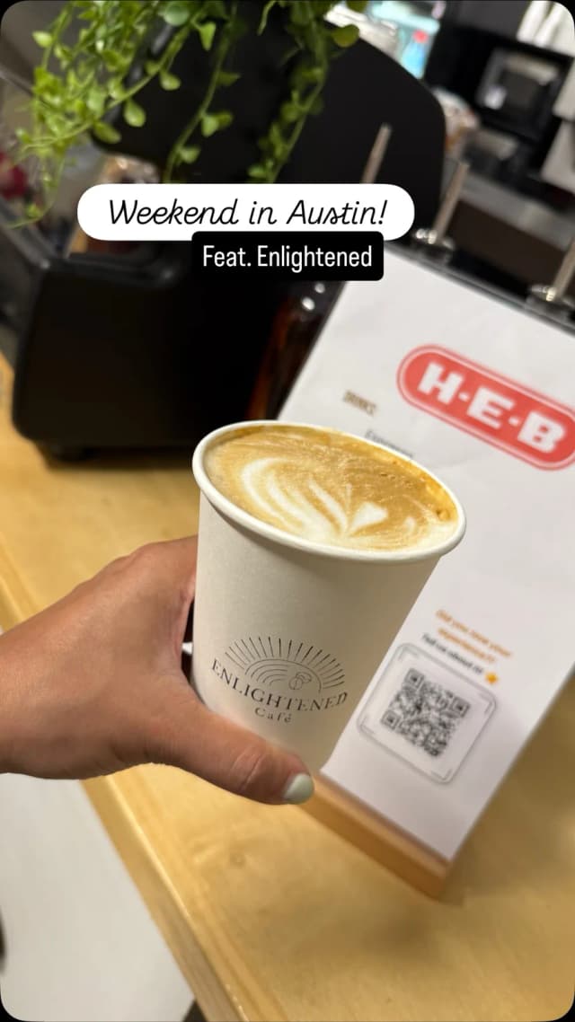 Hand-poured latte art in an Enlightened Café cup at a corporate coffee catering event